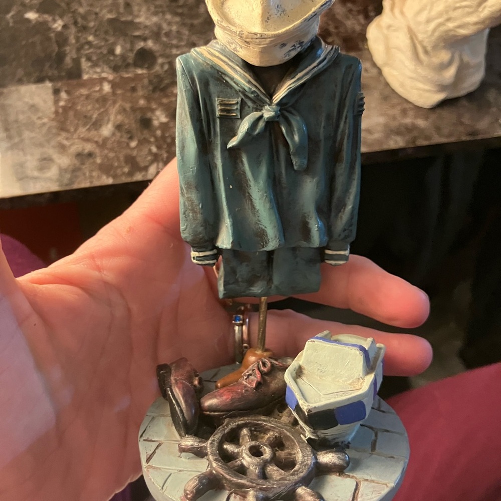 Blue and Brown Sailor Sculpture Art
